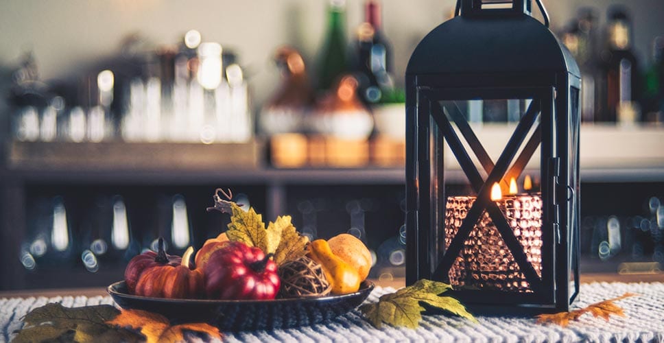 A farmhouse style table is decorated to convey the feeling of fall.
