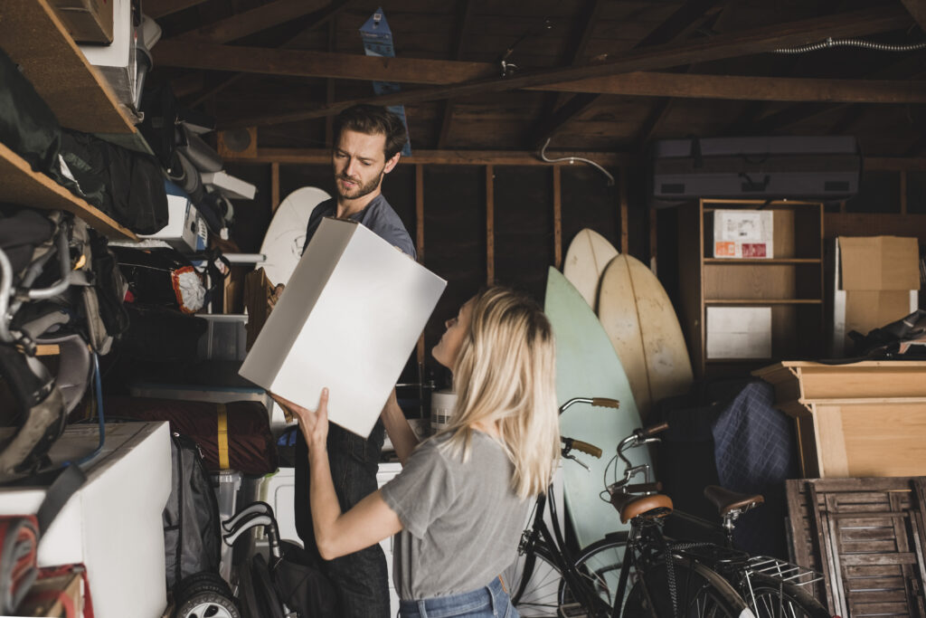 Mid adult couple arranging box in storage room