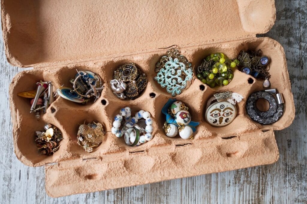 Jewelry organized in recycled egg carton to pack it for a move