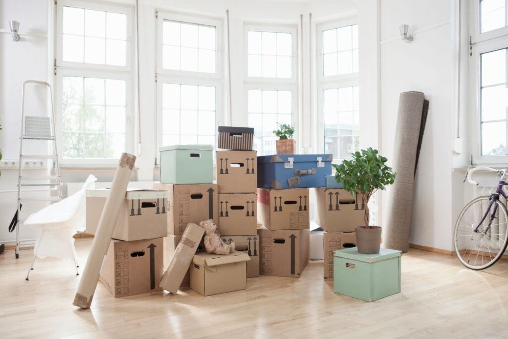 Moving boxes of different shapes and sizes in packed living room