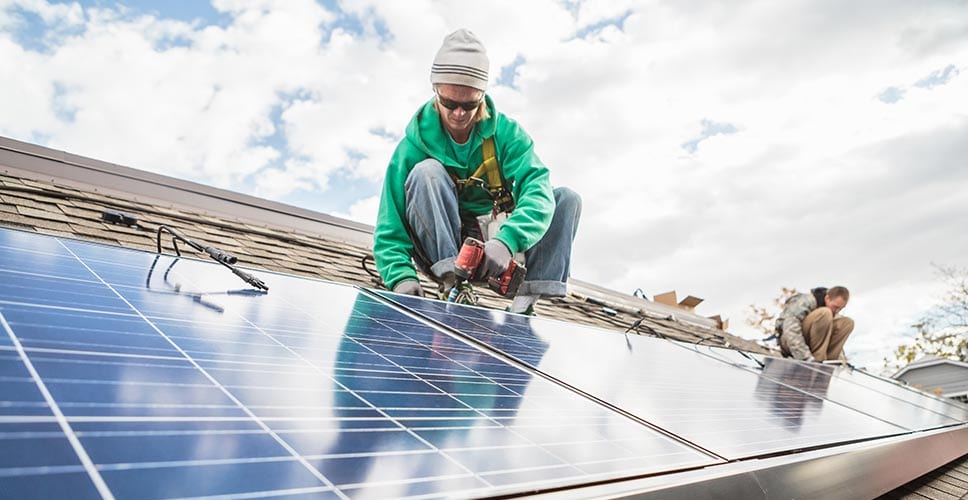 man installing solar panels