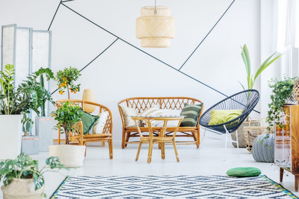 White living room with round chair, rattan sofa and table