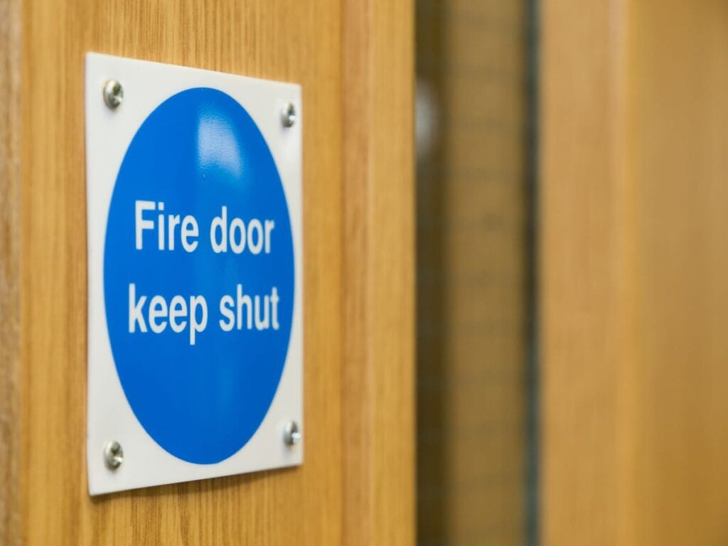 Fire door with sign that reads "Fire door keep shut"