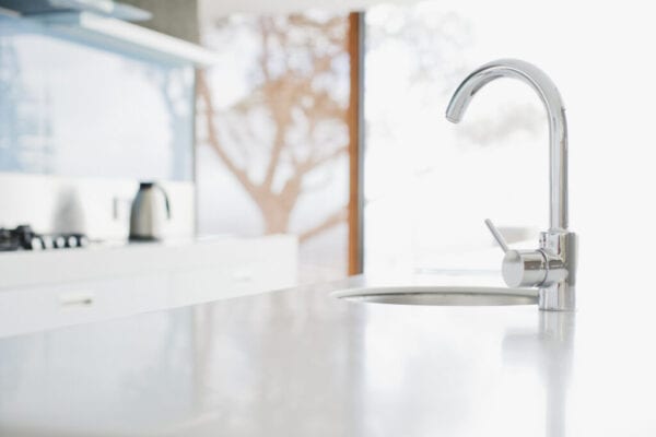 Close up of modern kitchen faucet and sink