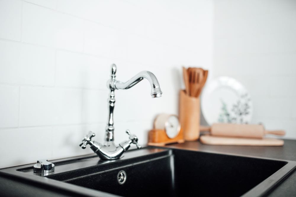 Black kitchen sink with silver faucet