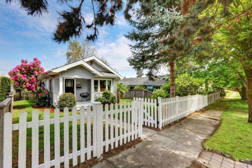 Craftsman house with white picket fence