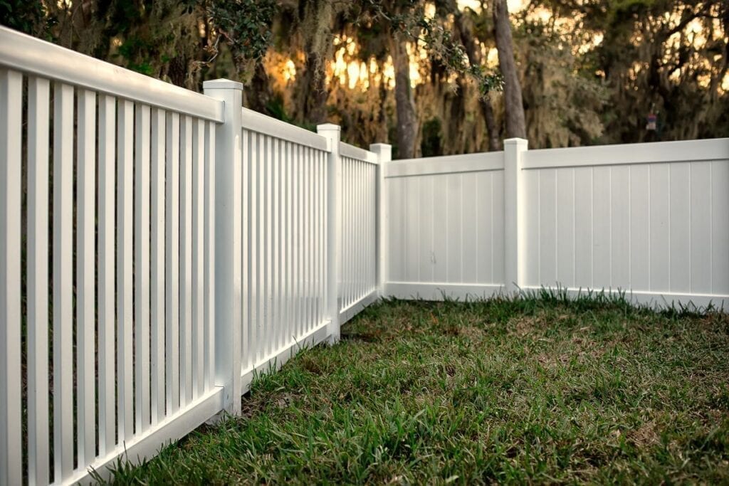 White vinyl privacy fence in backyard