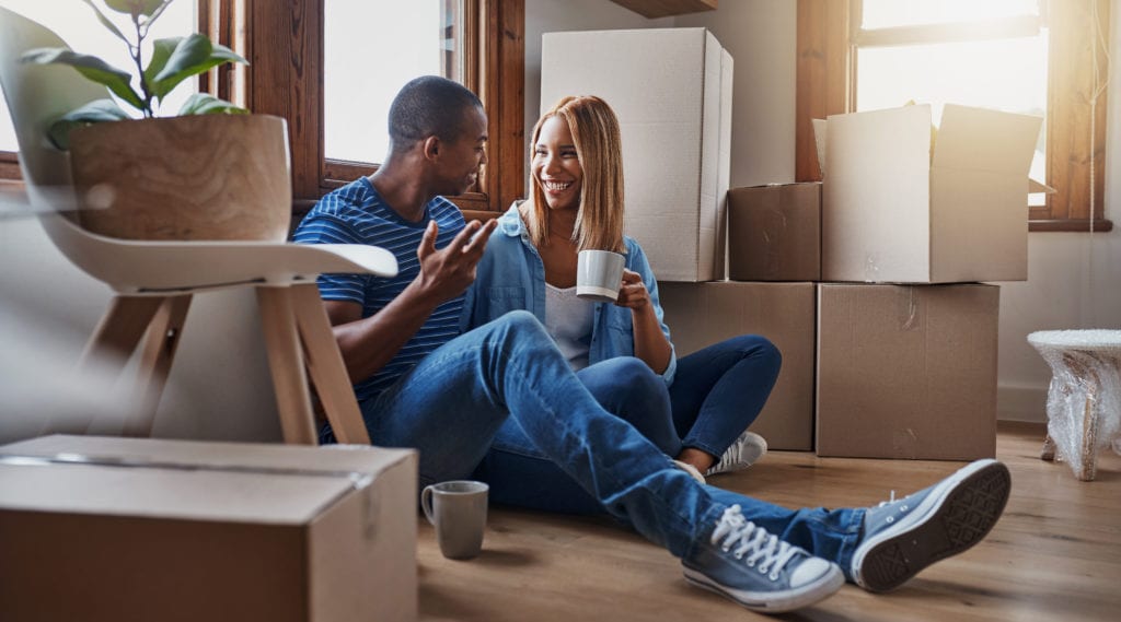 Two young first-time homebuyers settling into their new home