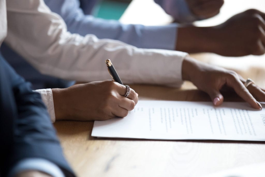 woman signs contract