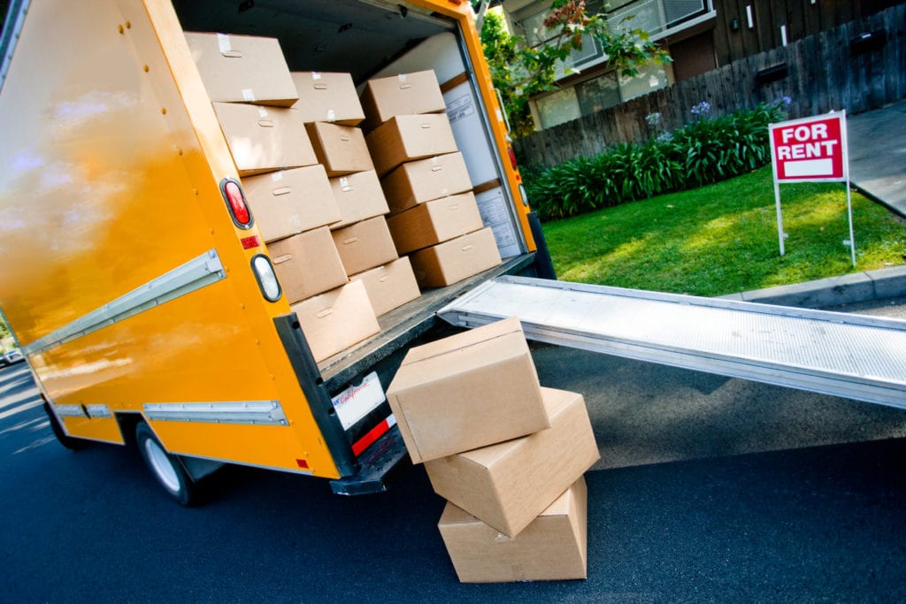 orange truck filled with moving boxes