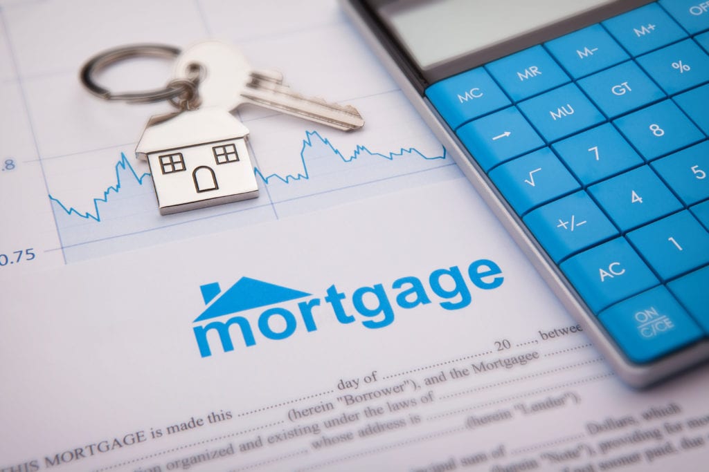 mortgage application with blue calculator and house key