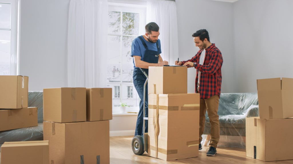 Man signs contract with professional mover to help carry boxes