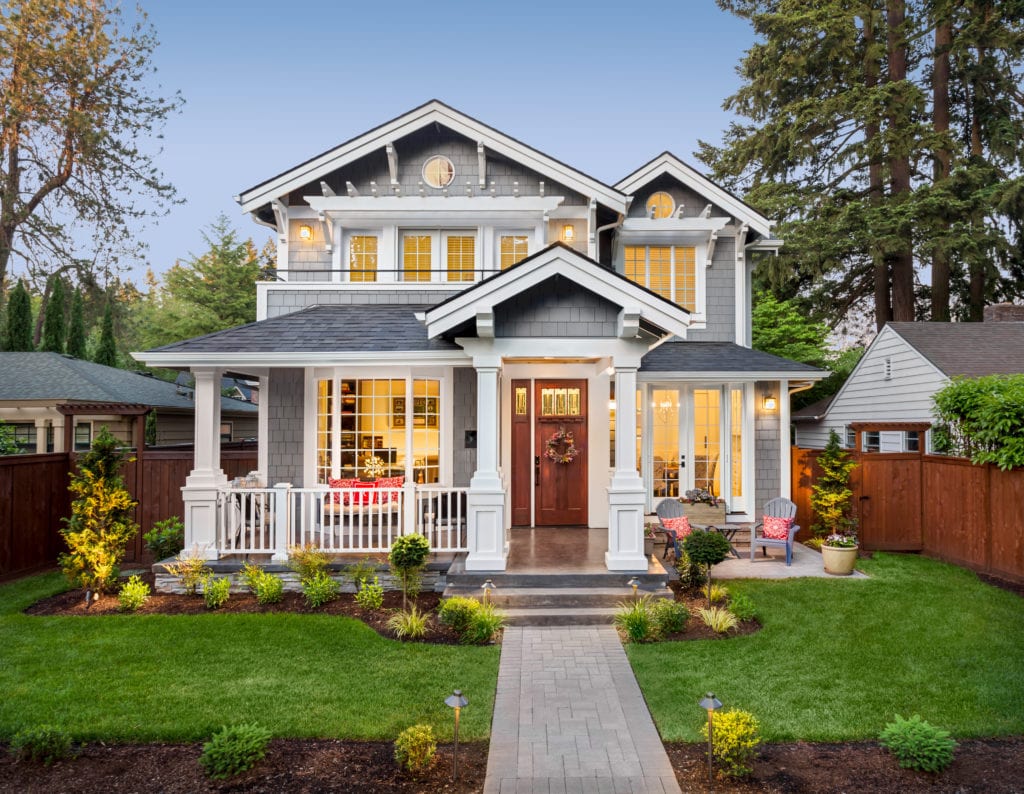 Gray house with well-kept lawn and landscaping