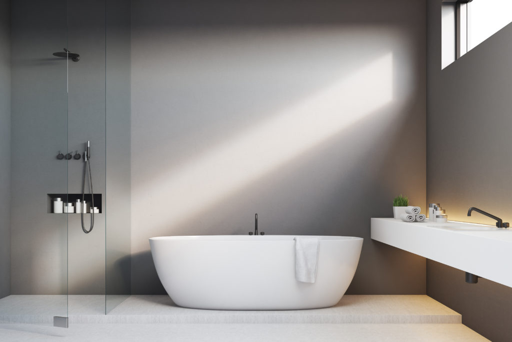 Gray bathroom with white bathtub