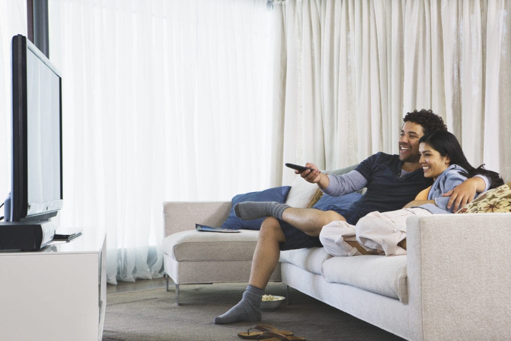 couple watching Verizon Fios tv in their home