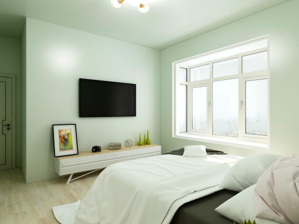 Light green bedroom facing television