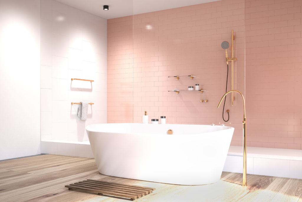 Luxury bathroom with white tub and pink shower tiles