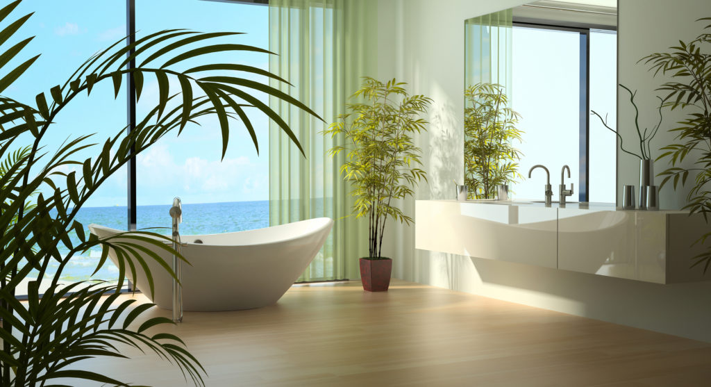Green bathroom with floor to ceiling windows and green plants