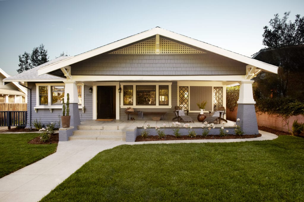 Blue-gray craftsman style house with green grass lawn