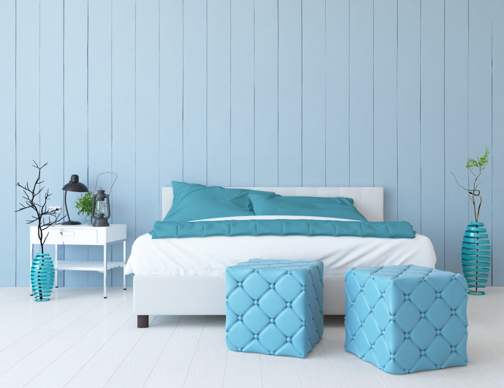 Light blue bedroom with light blue ottomans
