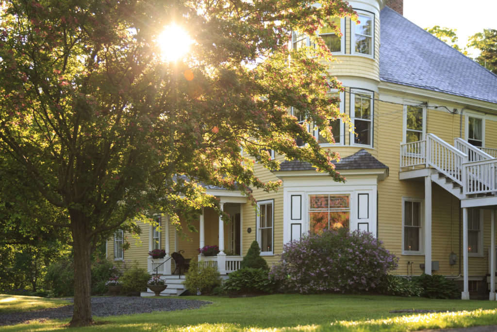 Facade of light yellow house in Maine