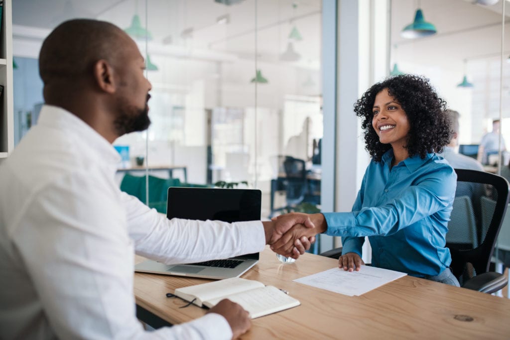 man and woman shaking hands at work