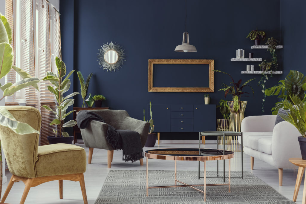 Living room with navy blue walls and copper decor