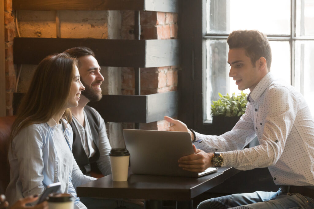 Couple talking to a mortgage broker over coffee