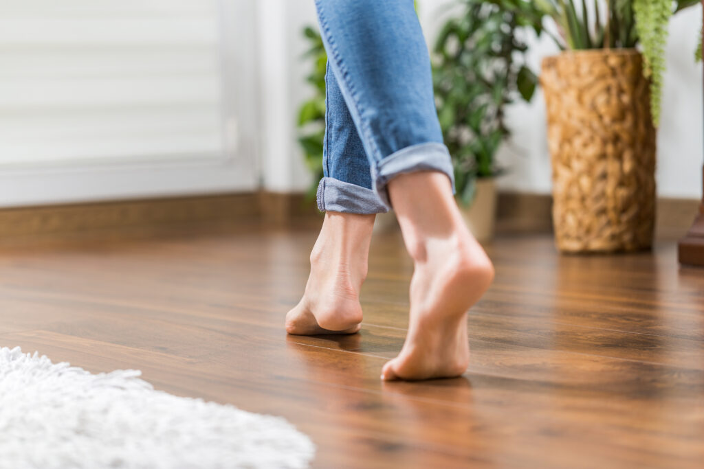 woman walking on hardwood floor barefoot