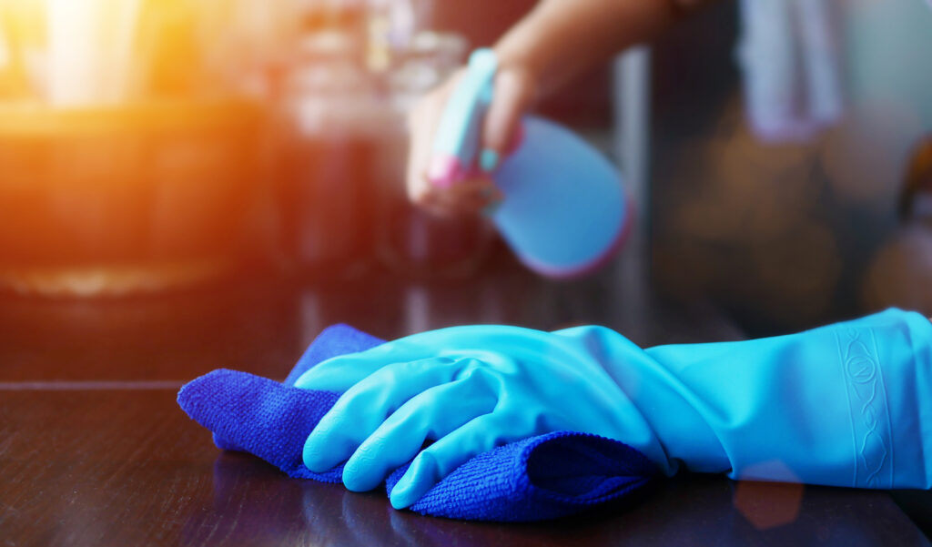 A woman cleans and disinfects her home to prevent the spread of the coronavirus