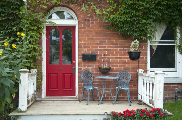Red outside door with a patio and seating