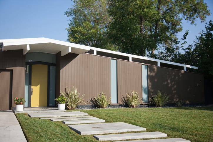 Exterior of modern home with mustard front door