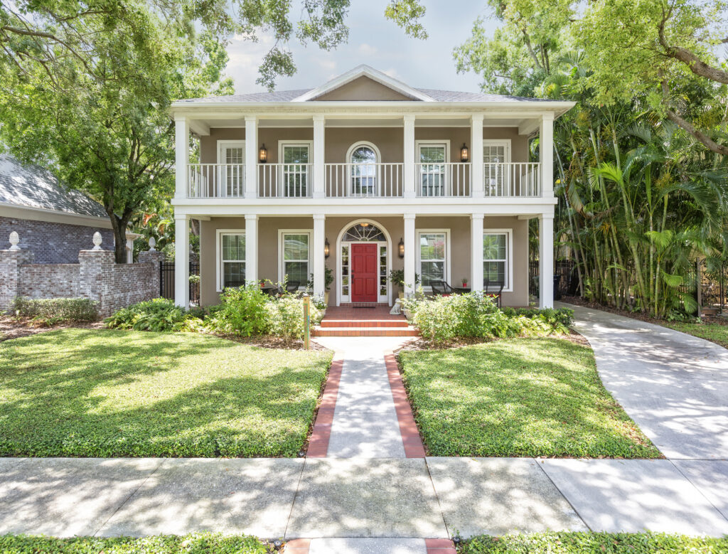 coral front door on colonial home