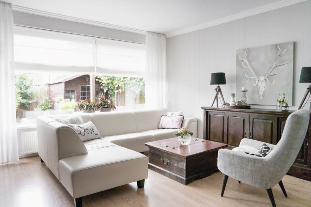 Neutral colored living room with gray wall paint and neutral furniture