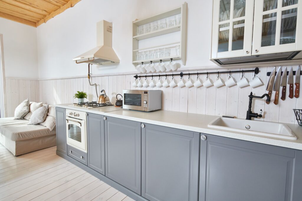 Modern kitchen with counters painted white, and cabinets painted gray