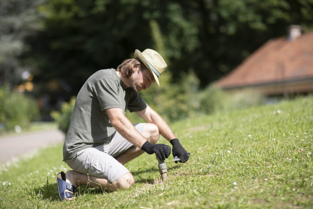 Man installing diy sprinkler system in lawn