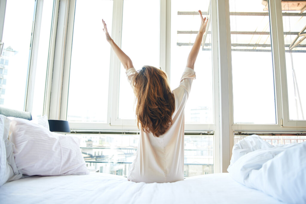 Woman waking up and stretching in the morning