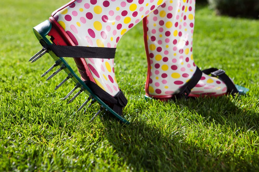 aerating lawn manually with boot attachment