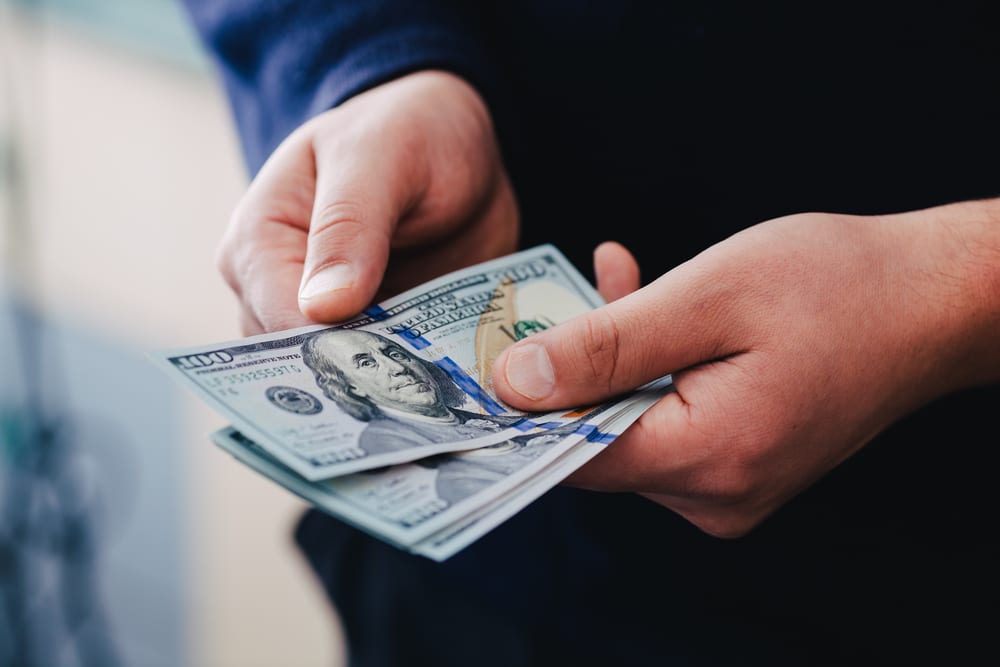 Man holding cash of security deposit