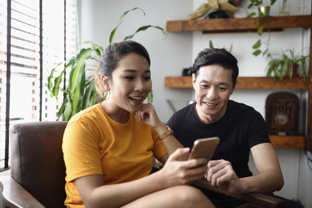 Couple watching virtual apartment tour on iphone