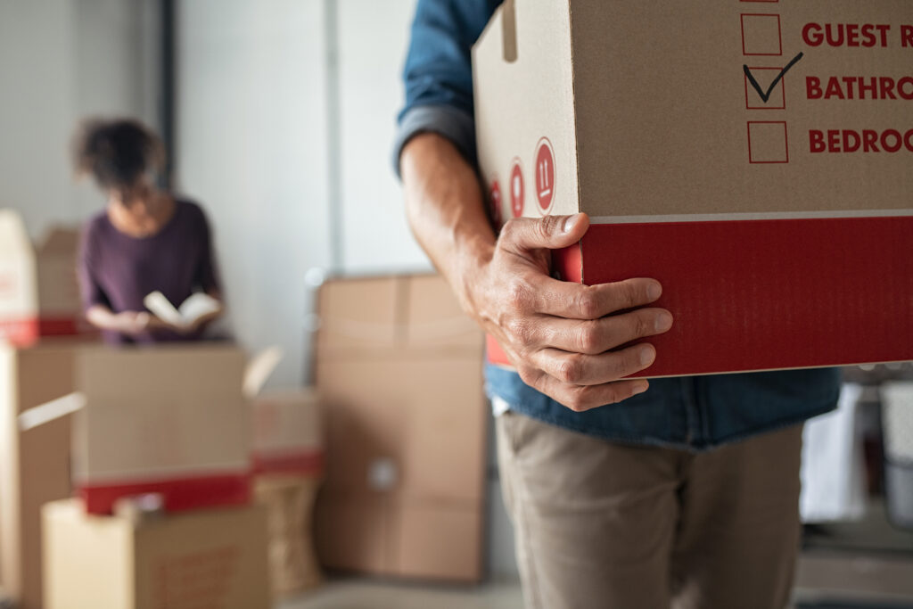 Closeup of man hand holding cardboard at new home.