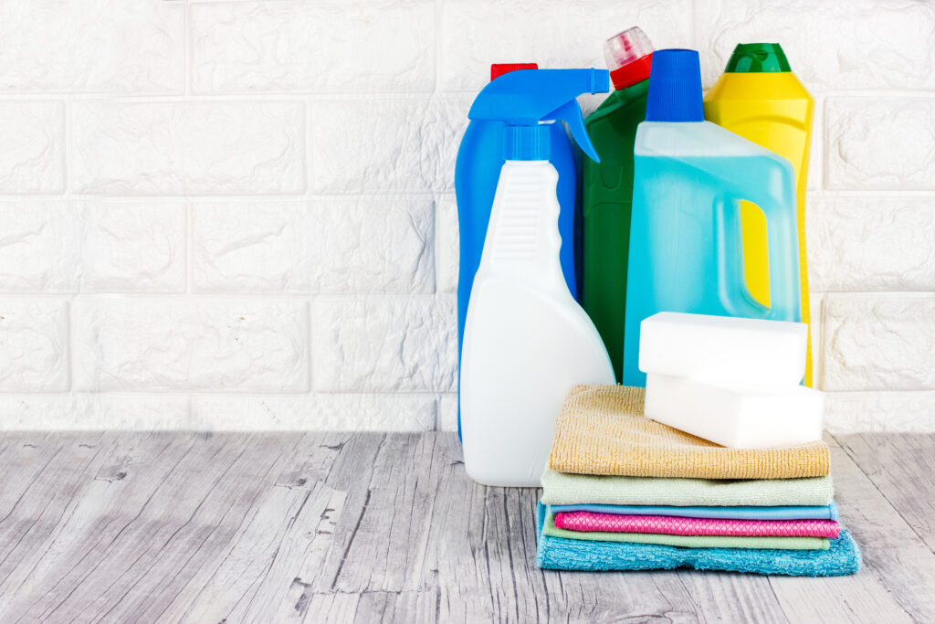 Close-Up Of Cleaning Equipment On Table Against Wall