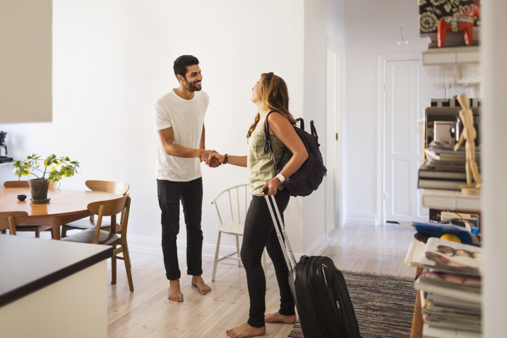 Young man greeting subletter at his apartment