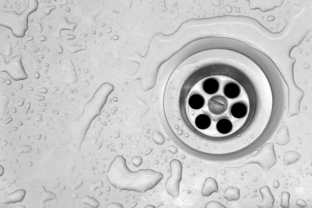 View of the sink, drain and flowing water