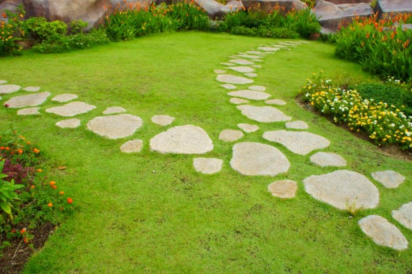 Stepping stones of various sizes leading to a garden