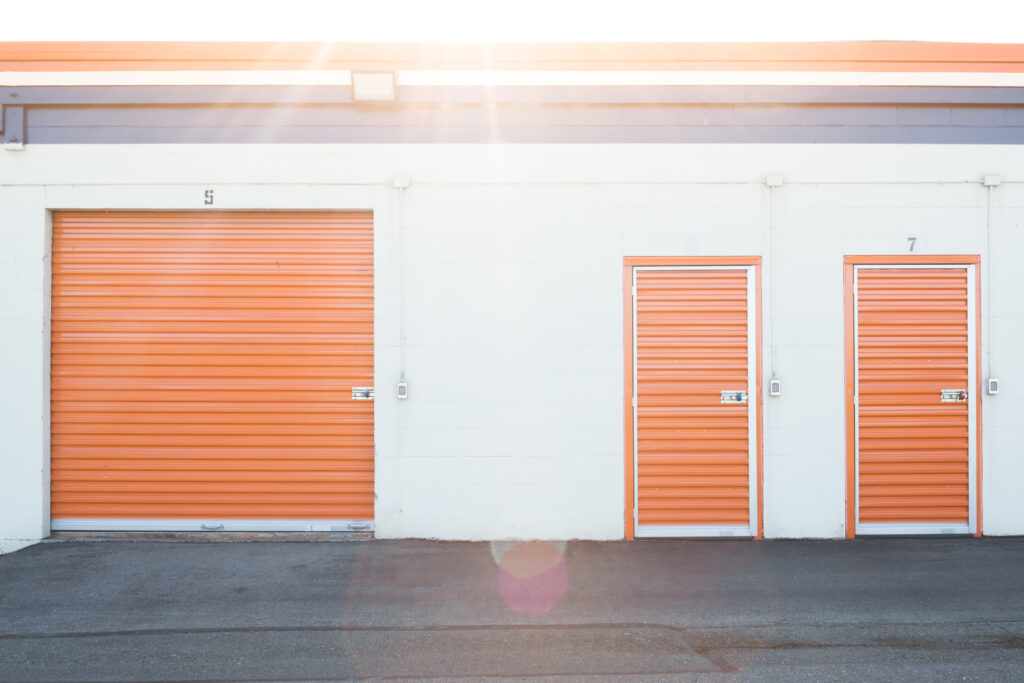 Sun overhead storage units with white walls and orange doors