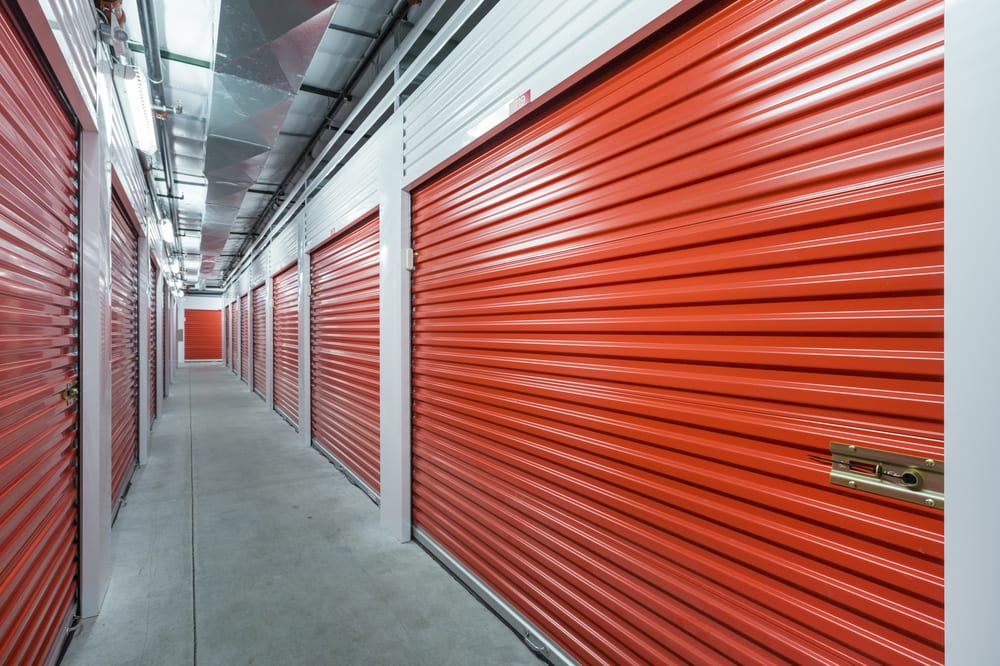 Inside of a storage facility with red pull-down doors