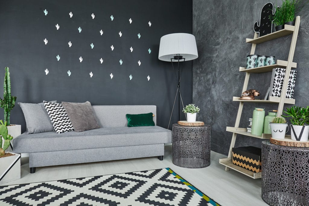 Room with black cactus wall decor and sofa