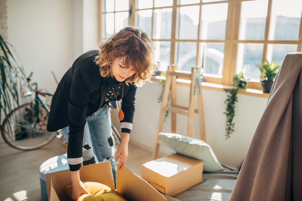 Young woman moving in into college apartment