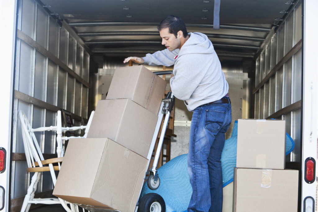 Professional mover loads things into moving truck